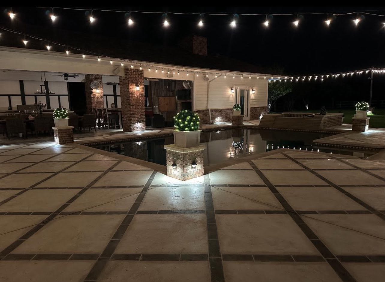 Austin pool terrace and tiled patio at night